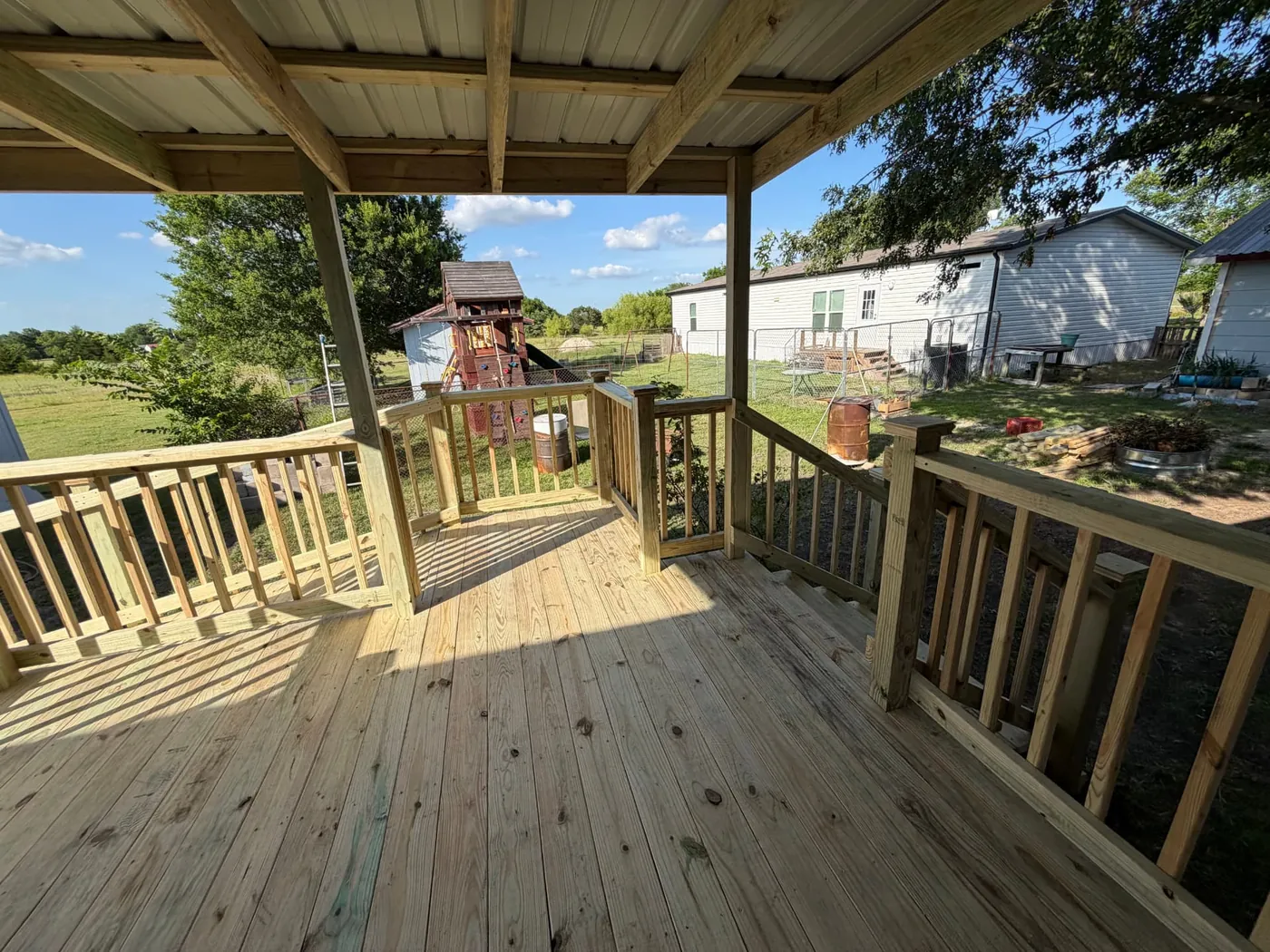 Covered deck with metal roof and pressure-treated railing
