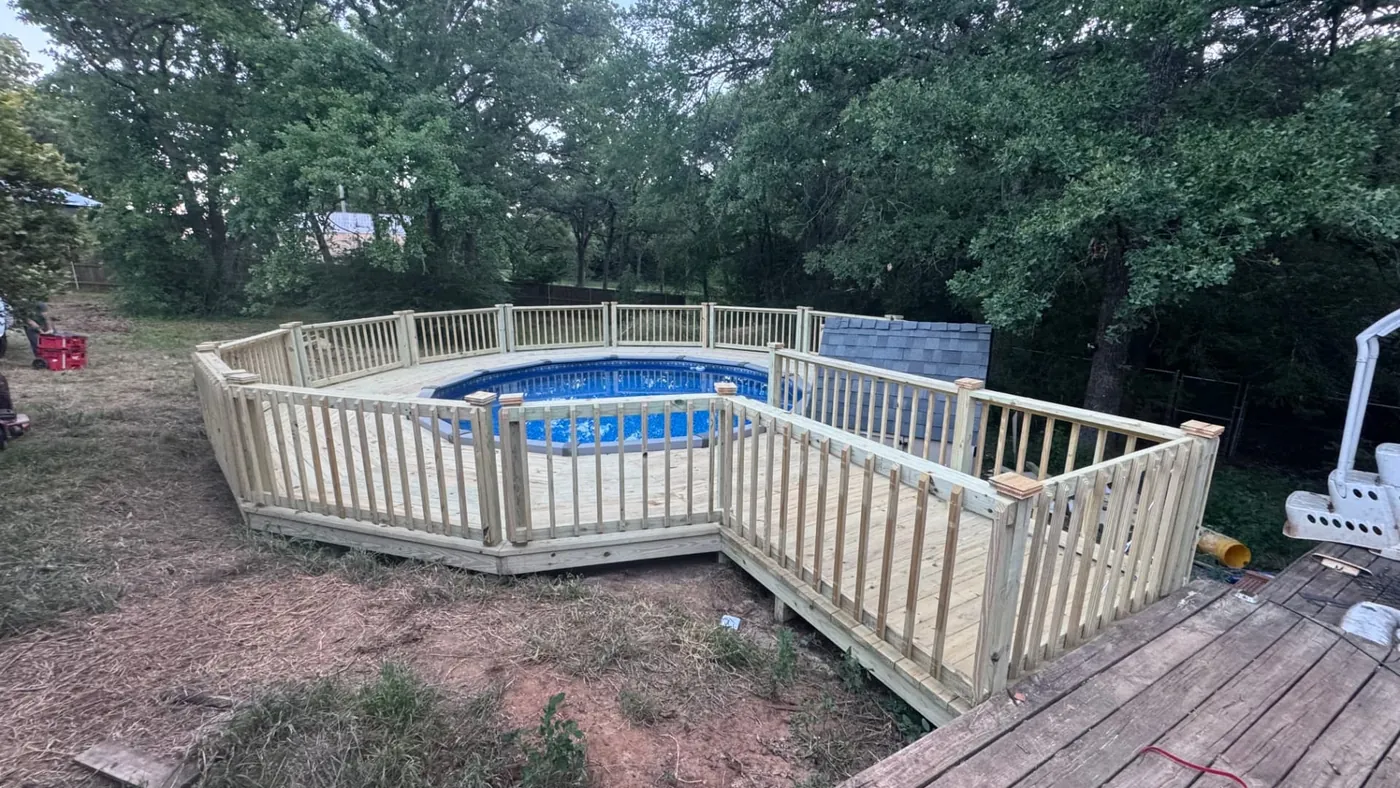 Wrap-around above-ground pool deck with railing and ramp walkway