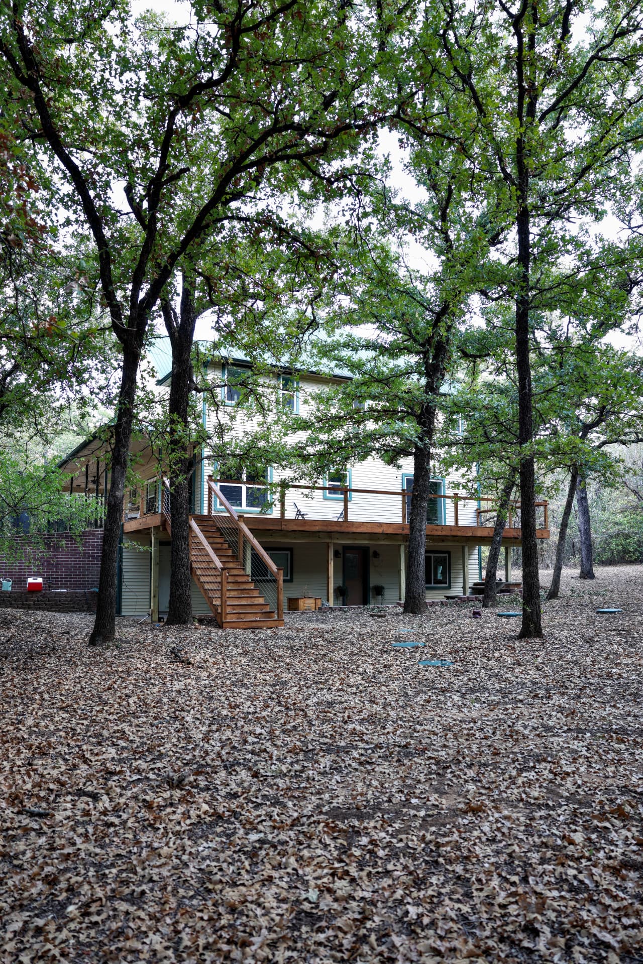 Completed elevated composite deck with cable railing on a two-story home in Grandview, TX