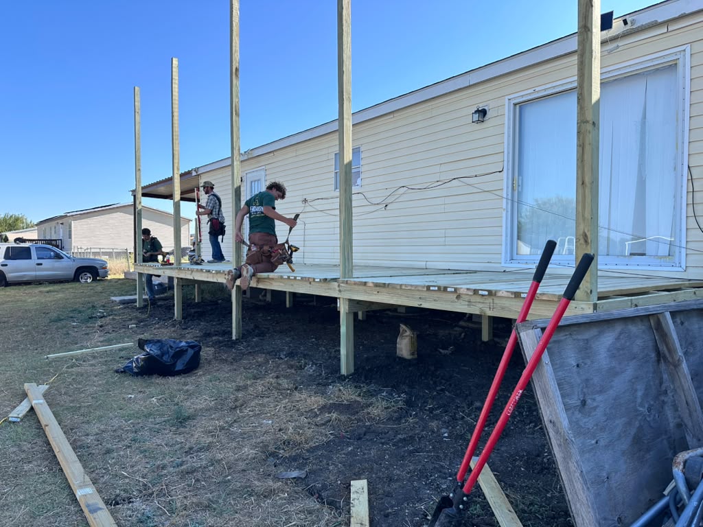 BenchMark Decks crew framing the new deck and setting roof posts at Violet's home