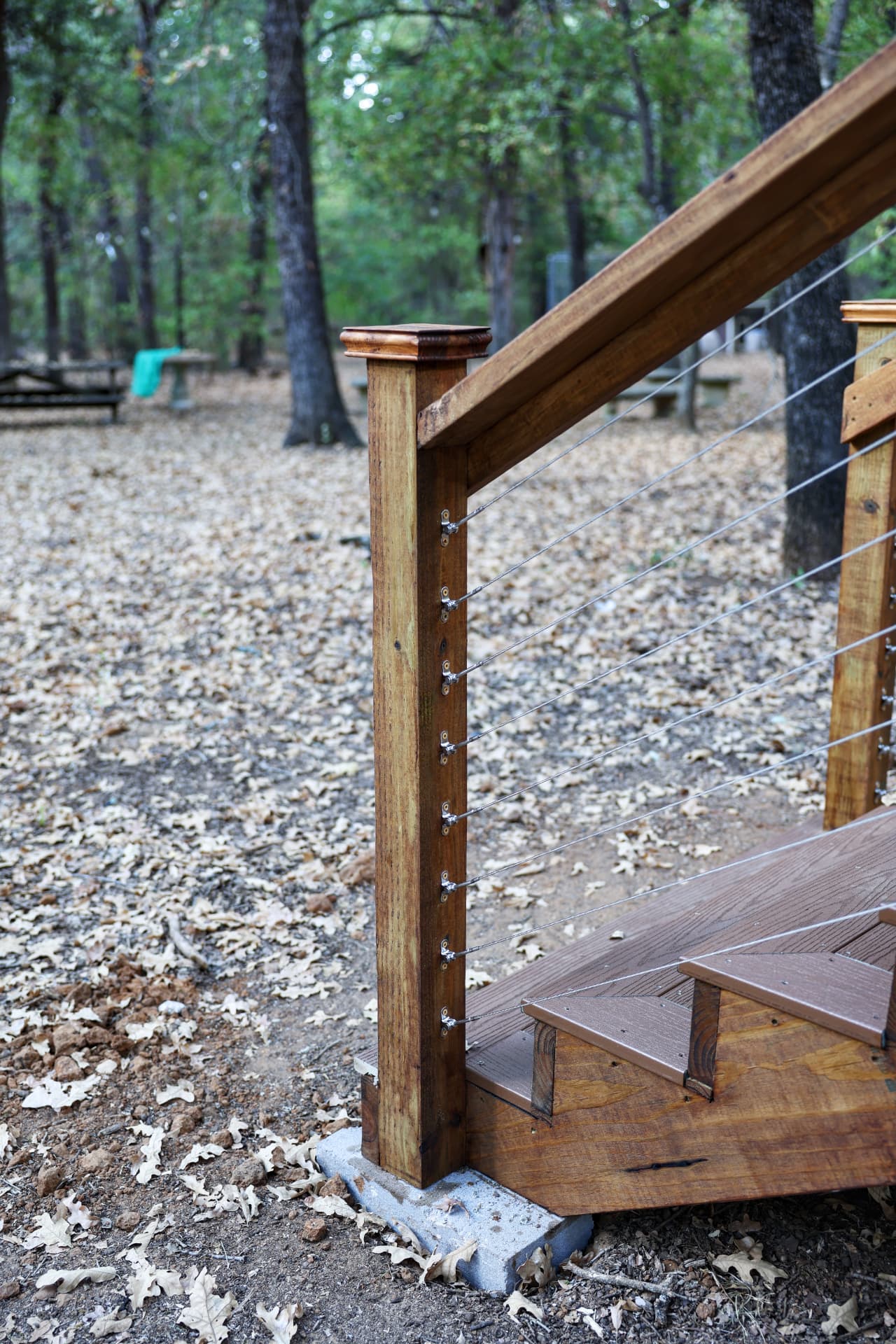 Composite stair landing with cable railing at the bottom of the run