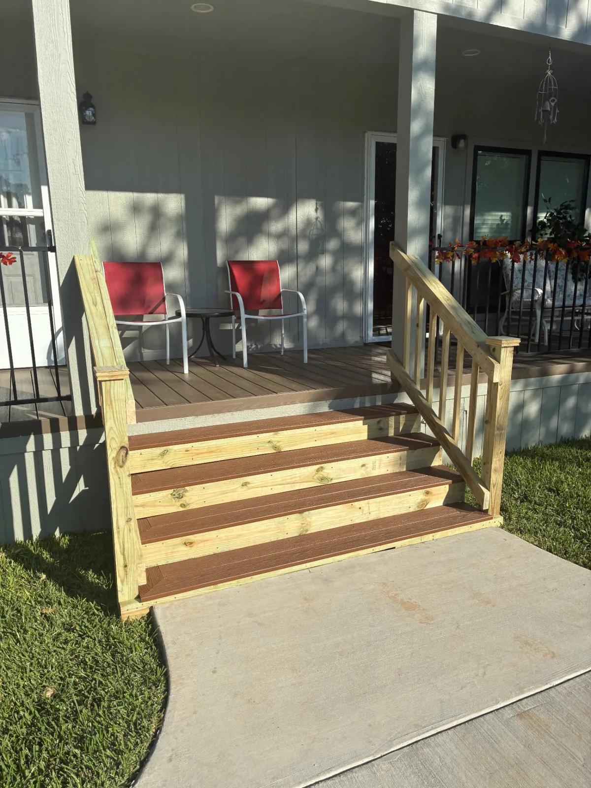 8 foot wide Fiberon Cabin composite steps with treated wood handrails, built by BenchMark Decks in Fort Worth, Texas