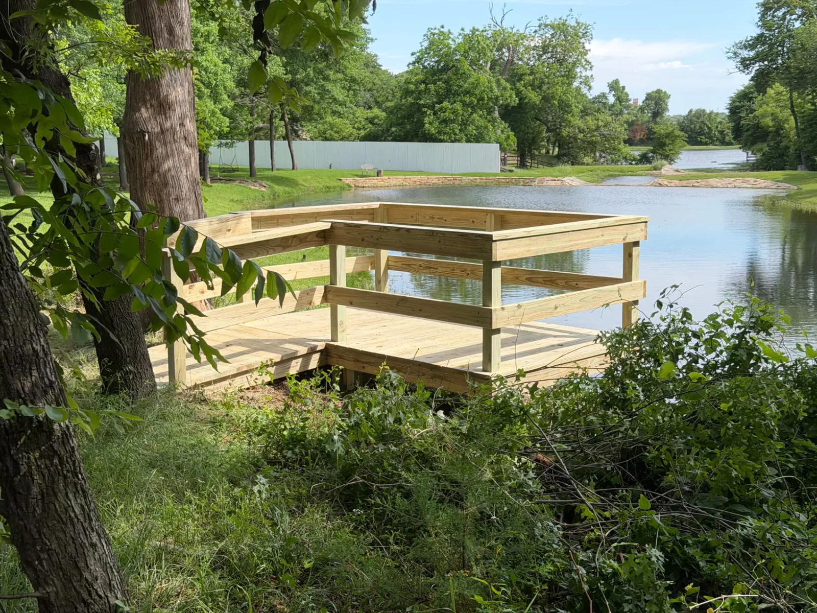 6x10 pressure treated pond deck with 2x6 railing before staining, built by BenchMark Decks in Weatherford, Texas
