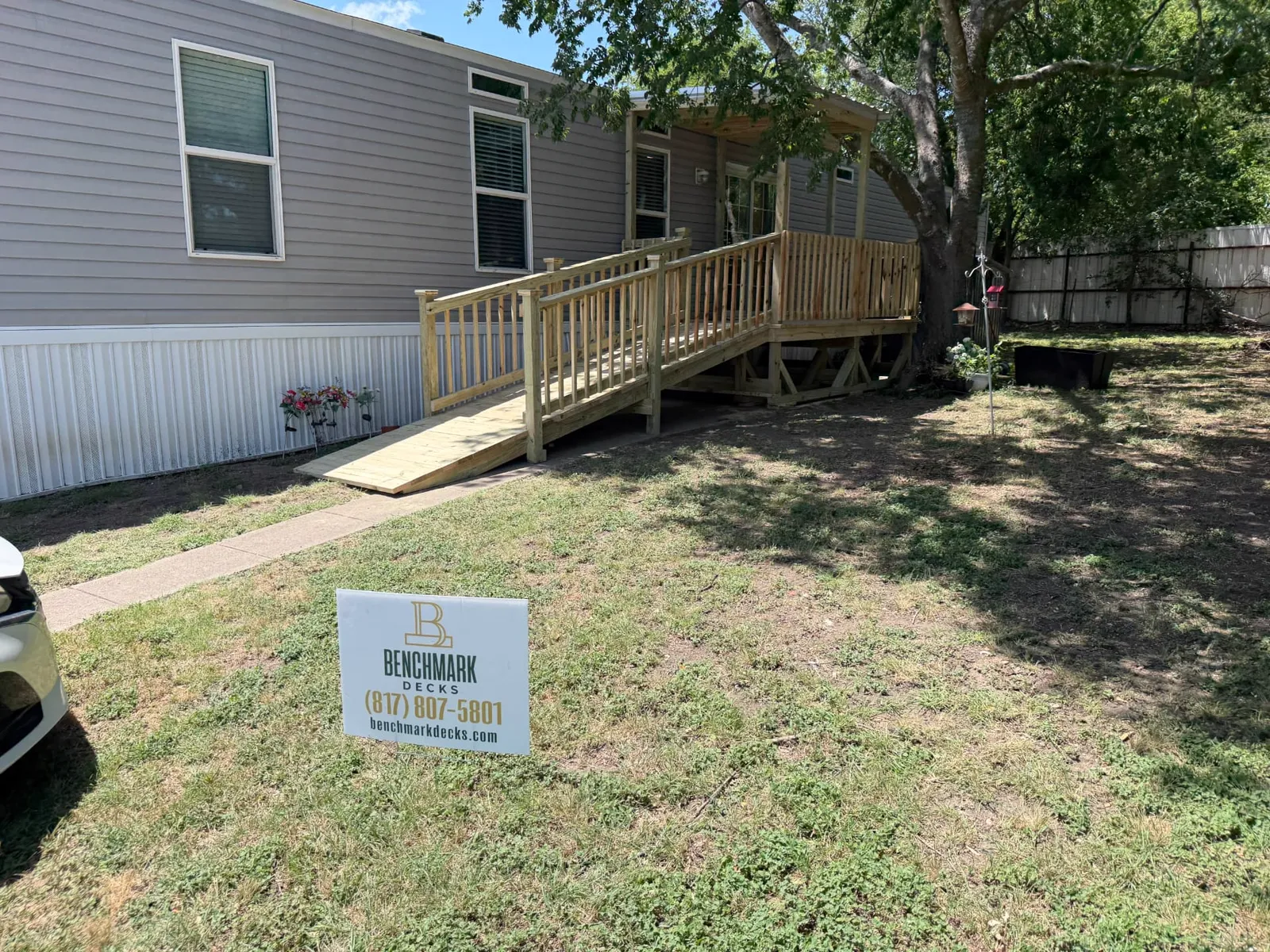 4x16 wood ramp with railing leading to a covered deck, built by BenchMark Decks in Waxahachie, Texas