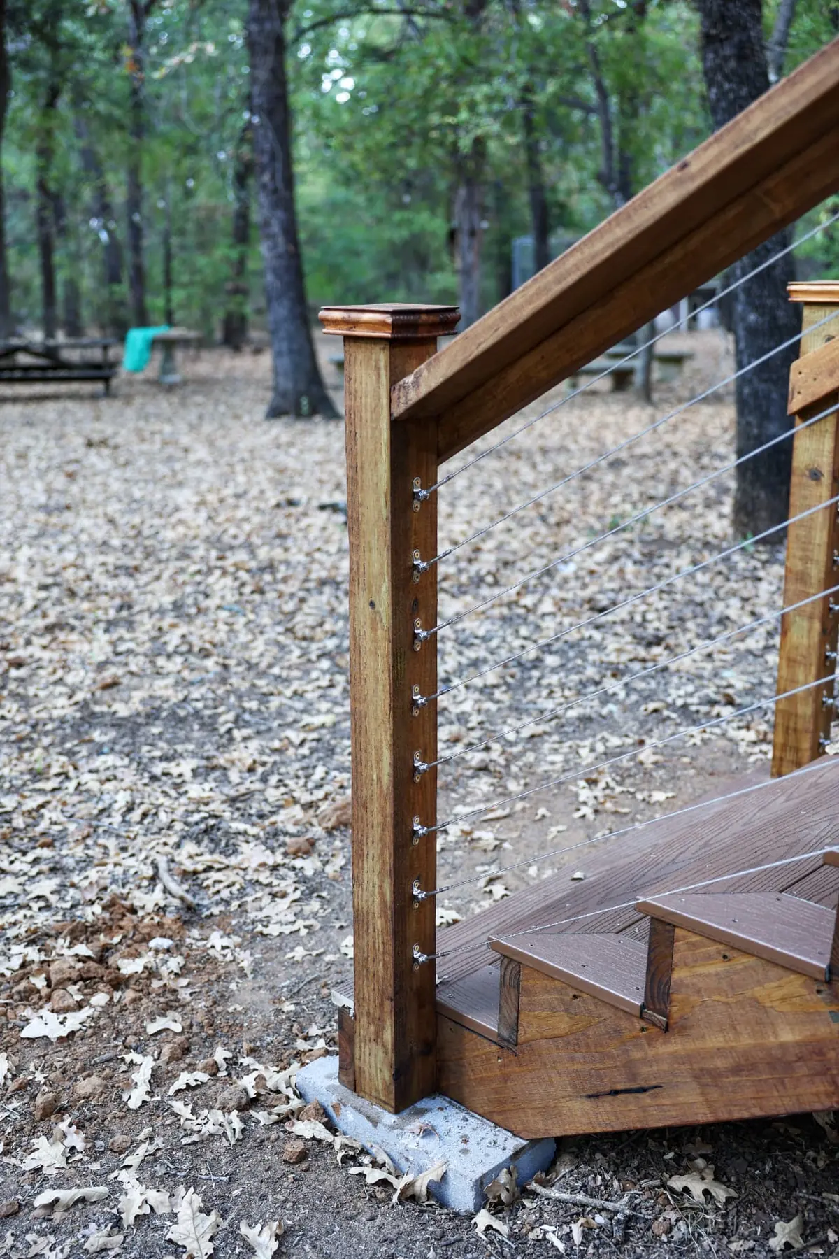 Composite stair landing with cable railing at the bottom of the run