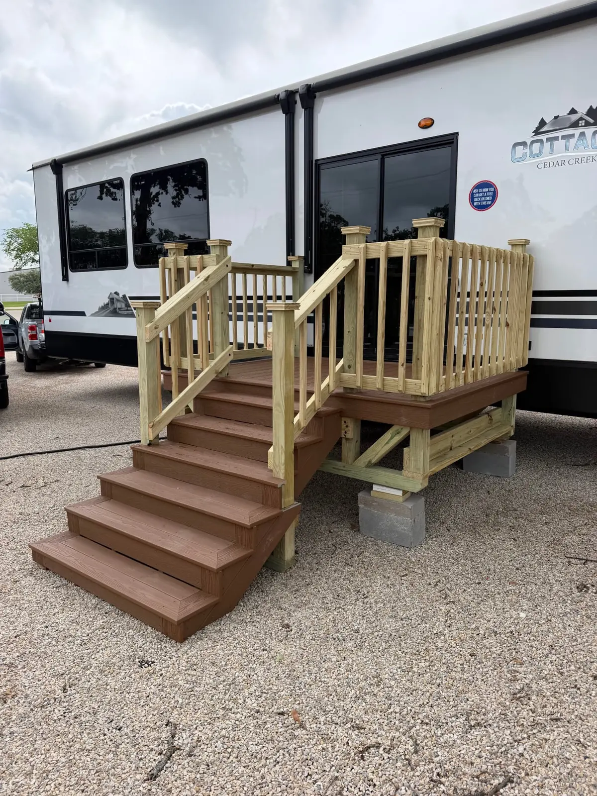 RV deck with composite decking, stairs, and pressure-treated railing