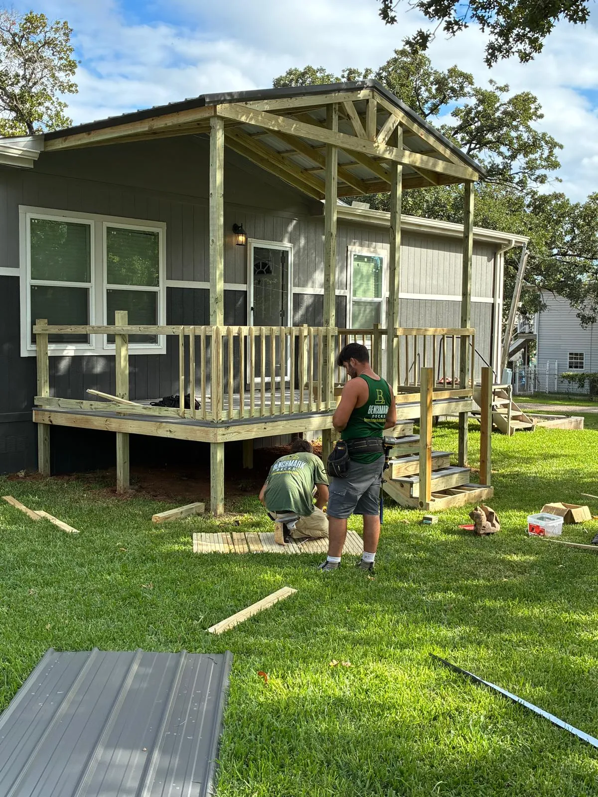 Crew framing the roof over a 10x16 composite deck, built by BenchMark Decks in Fort Worth, Texas