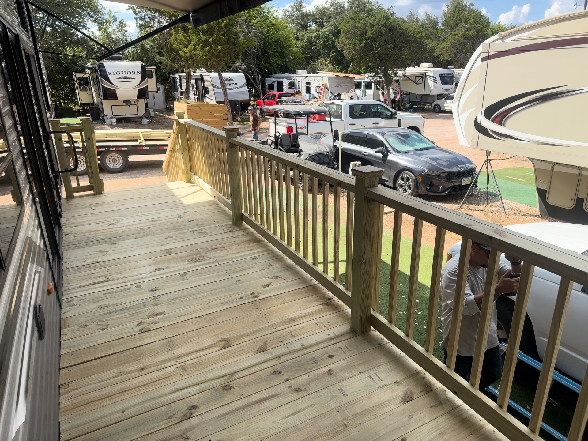 Pressure treated deck boards and spindle railing on an RV deck, built by BenchMark Decks in Killeen, Texas