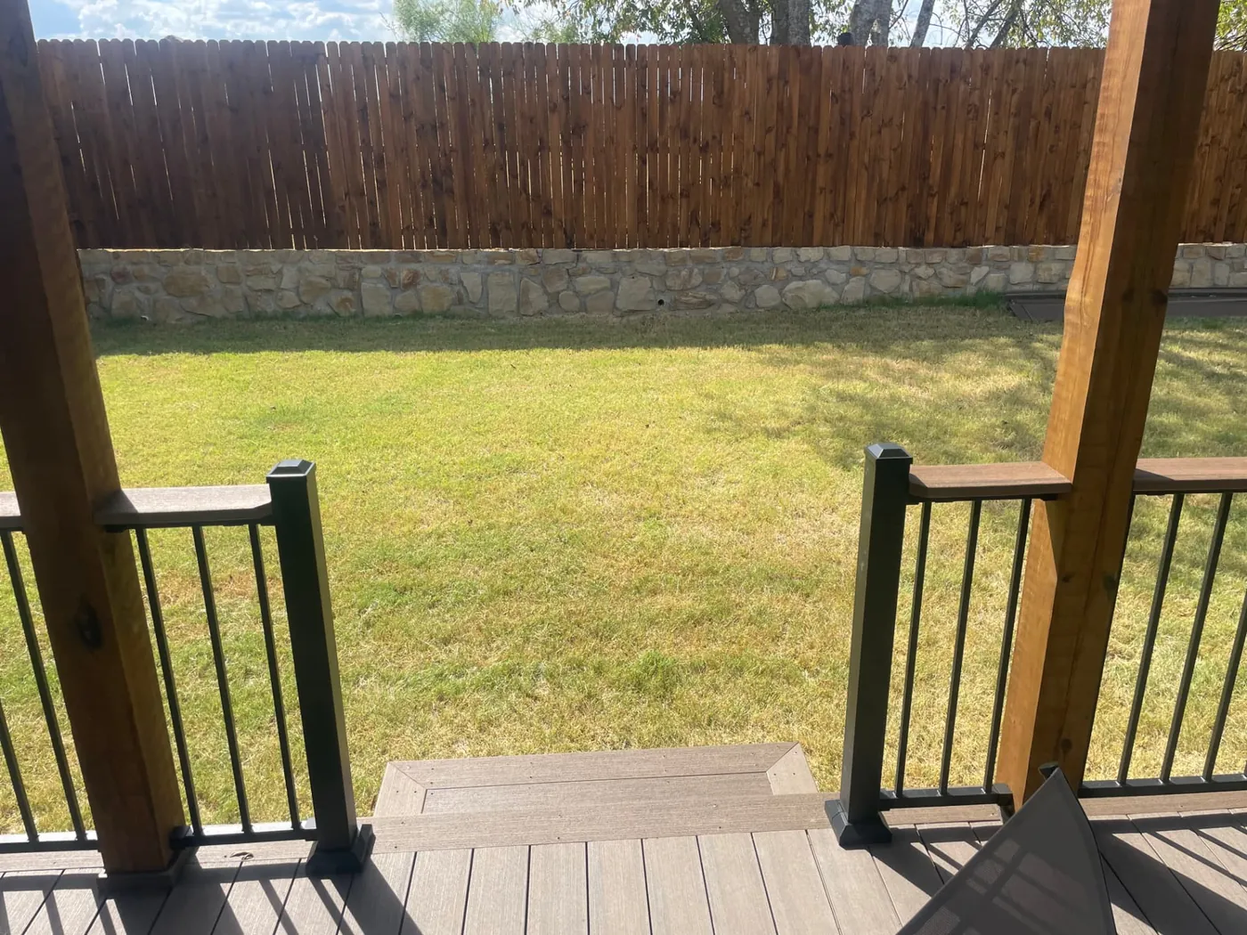 View from the finished deck stairs out to the backyard