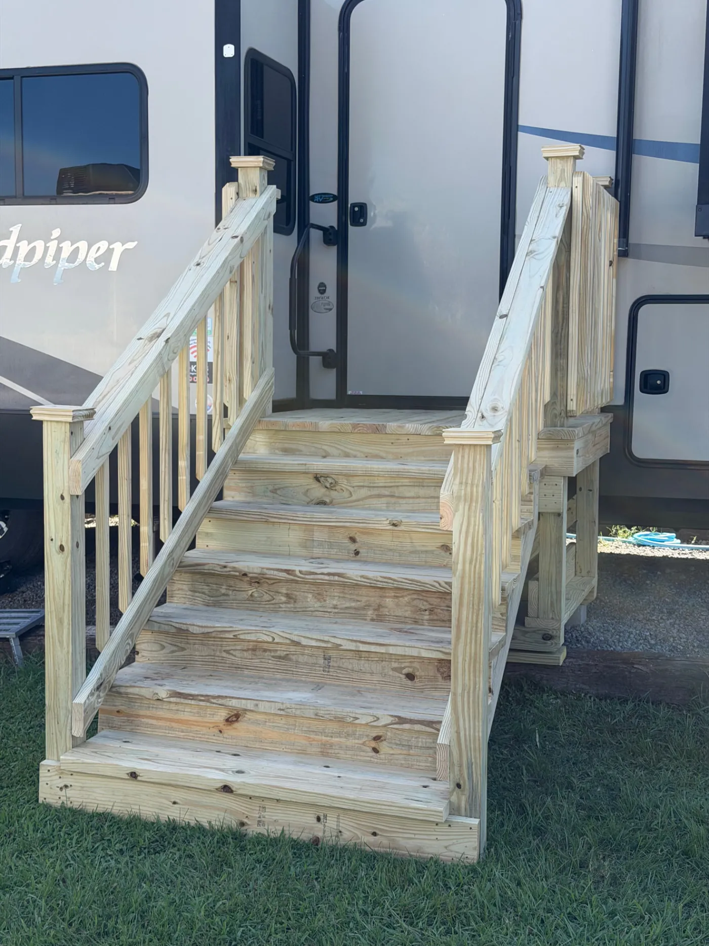 Pressure-treated RV entry stairs and landing with handrails