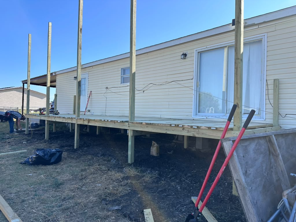 New pressure treated deck frame and roof posts set along the back of Violet's home in Joshua, TX