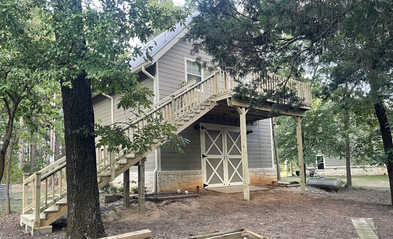 Second-story deck with stairs and covered storage below