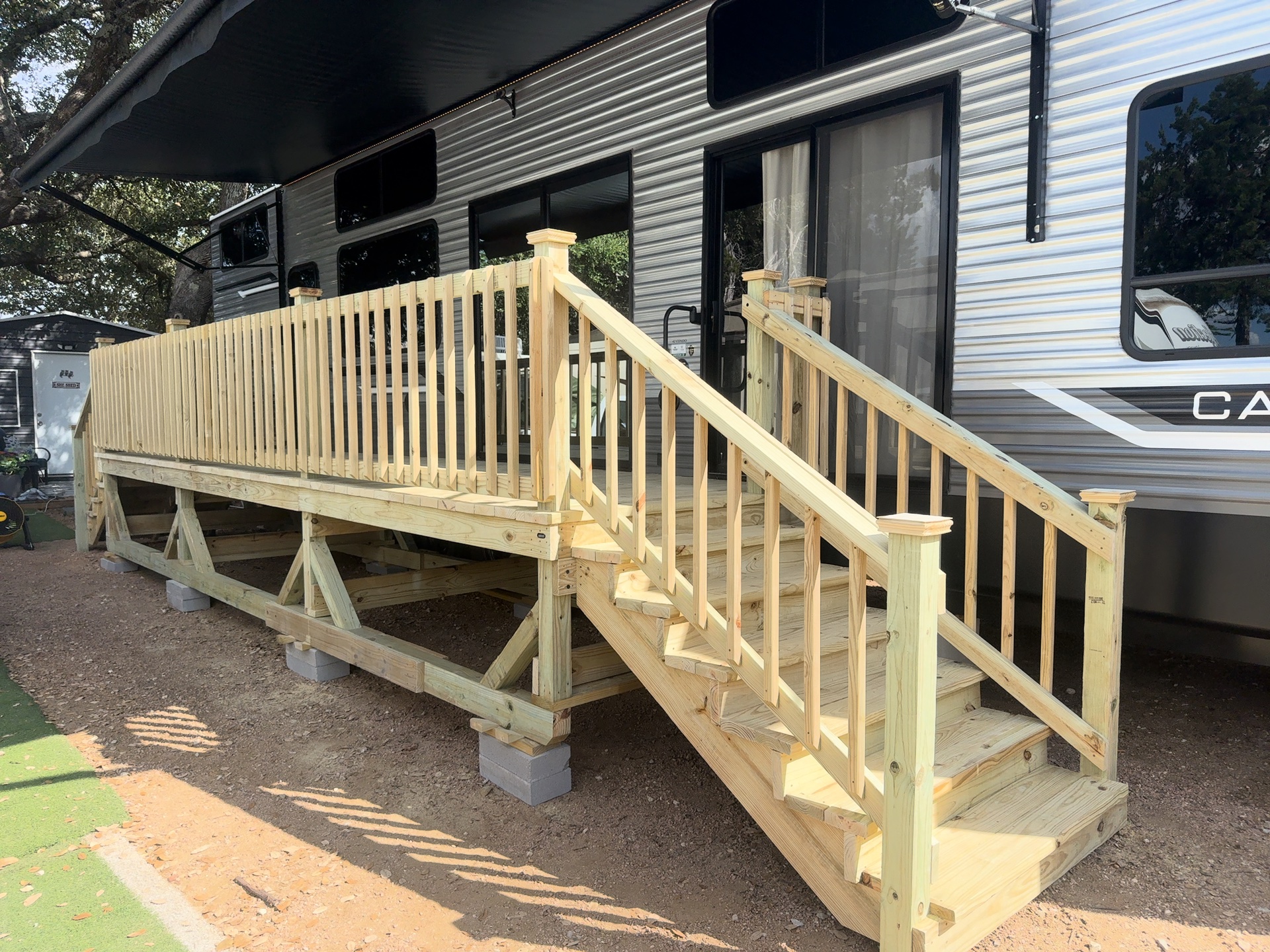 6x22 pressure treated RV deck on blocks with wood railing and stairs in Killeen