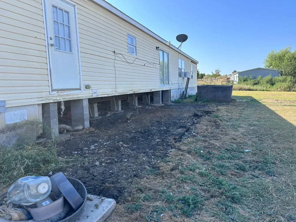Cleared area along the home after the old deck was removed