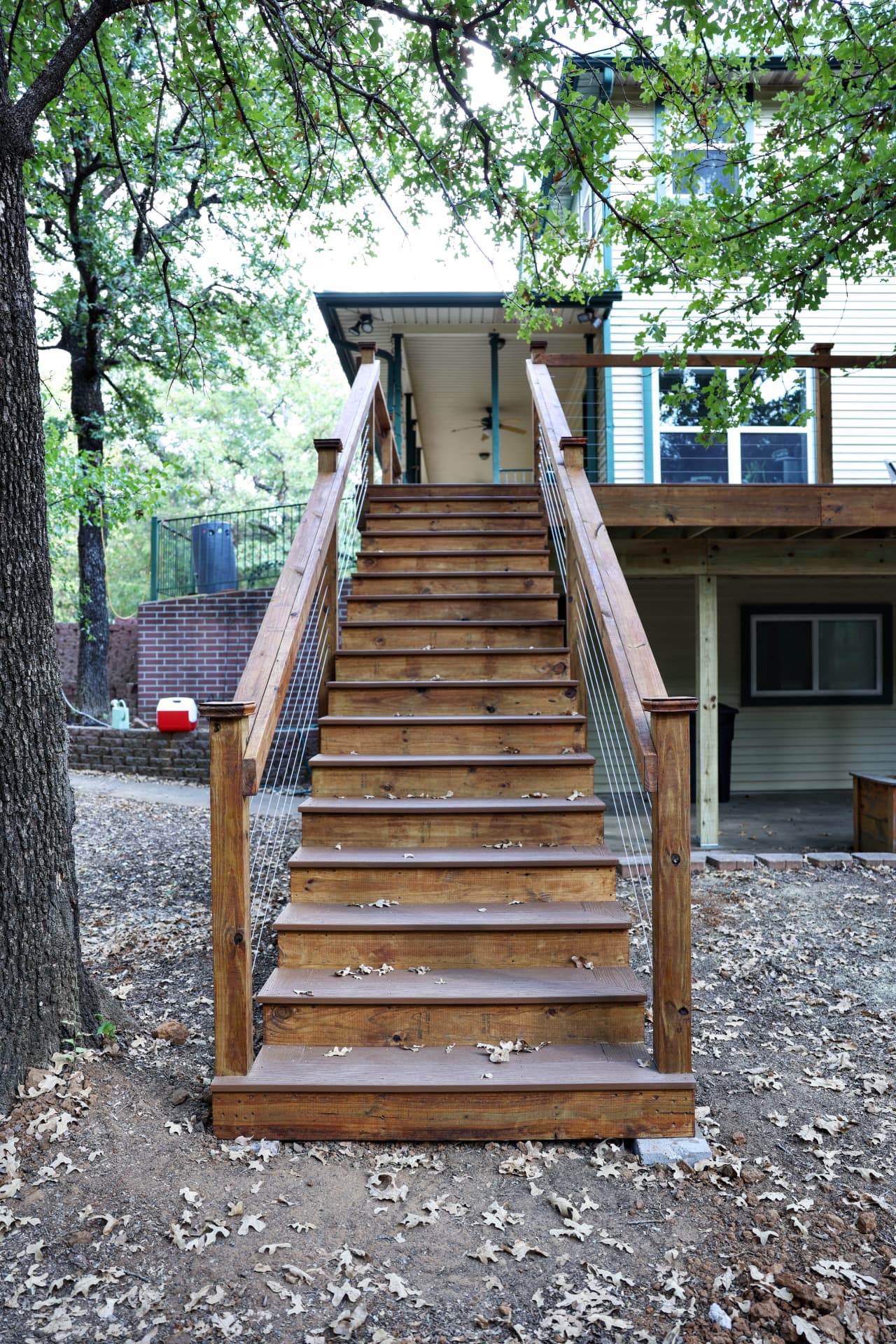 Tall composite stair run up to a second-story deck