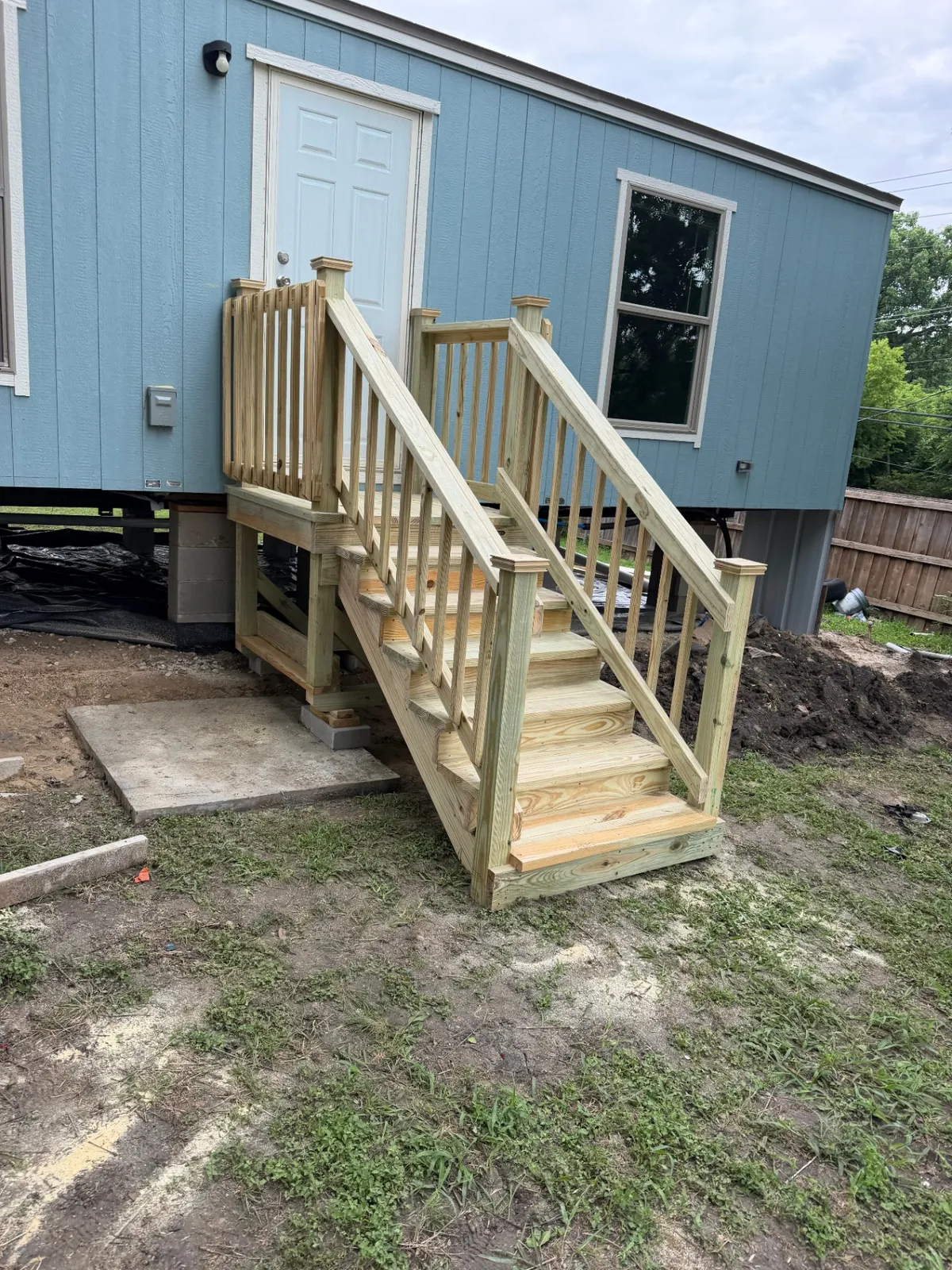 4x4 pressure treated landing and stairs with handrails, built by BenchMark Decks in Dallas, Texas