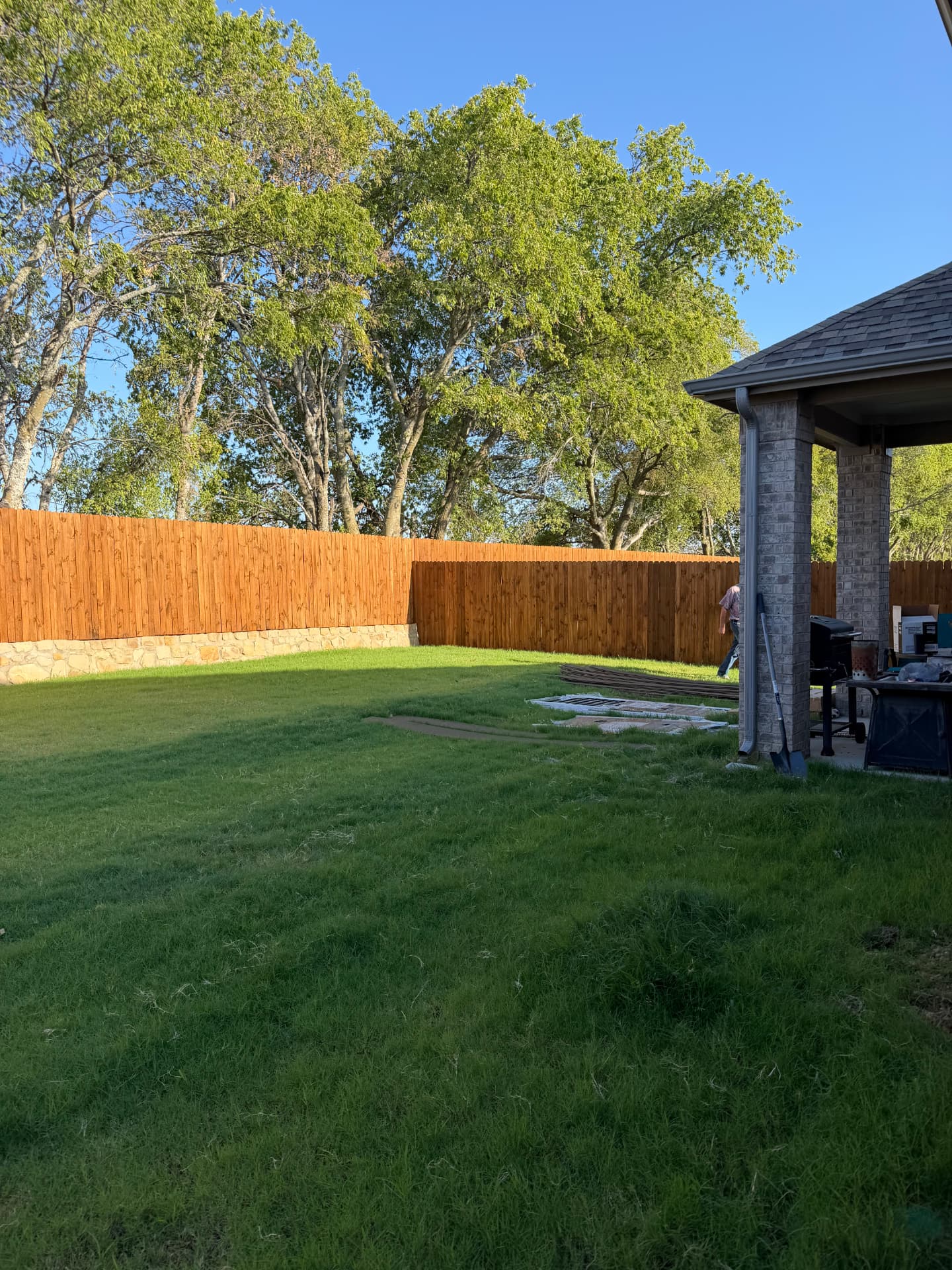 Materials staged in the backyard before framing