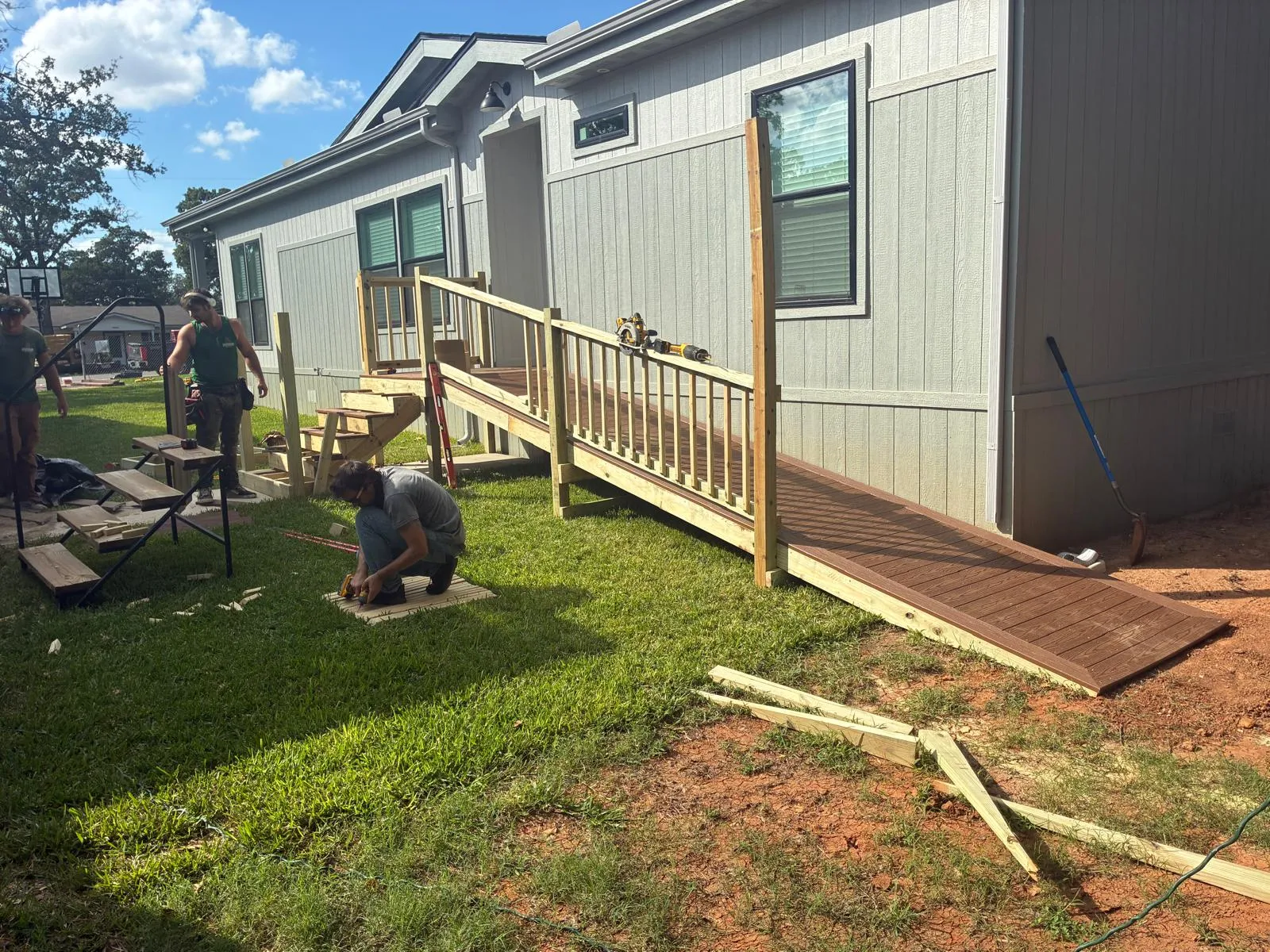 Crew installing a composite ramp and stairs, built by BenchMark Decks in Fort Worth, Texas