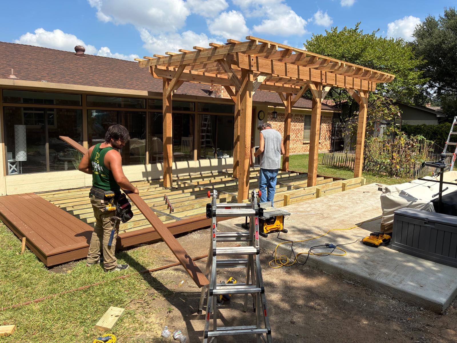 Cedar pergola installed over Danny's new deck while the crew installs composite decking