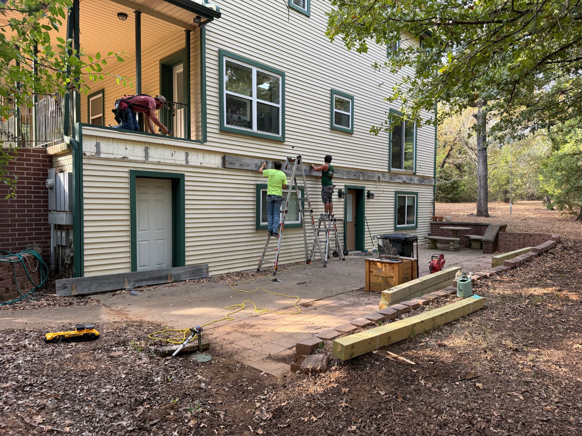 Crew removing old ledger and trim during tearout at Greg's Grandview, TX home